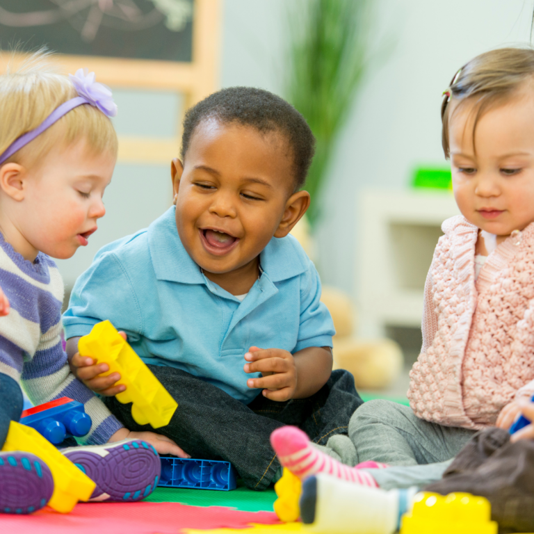 smiling babies in nursery setting