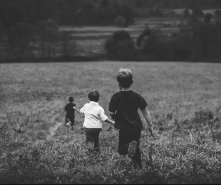 Boys running in field