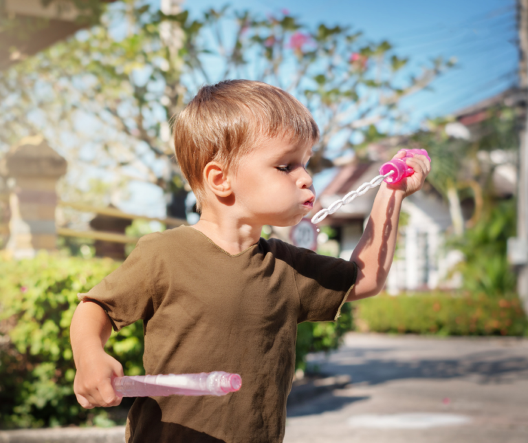 boy blowing bubbles
