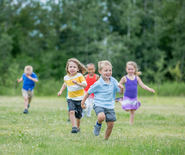 boys and girls running in field