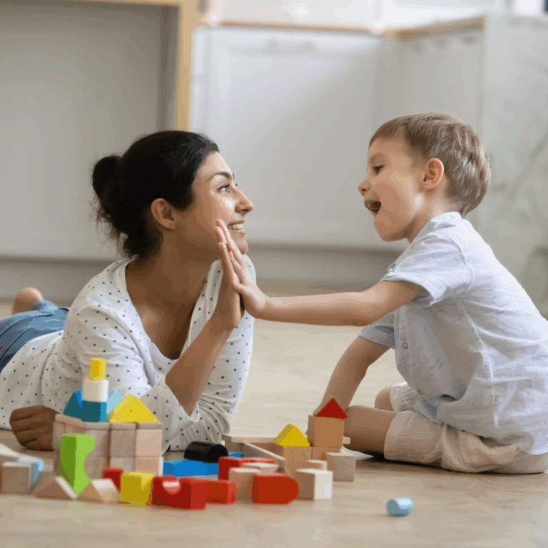 A Preschool teacher and a child playing together and giving high five to success