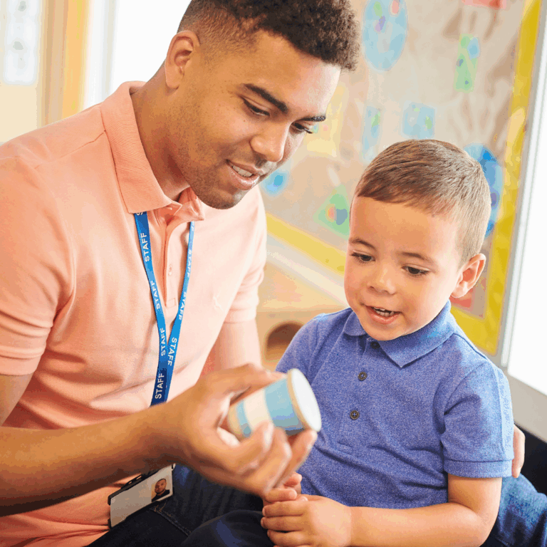 A male educator in early years supporting a child at play