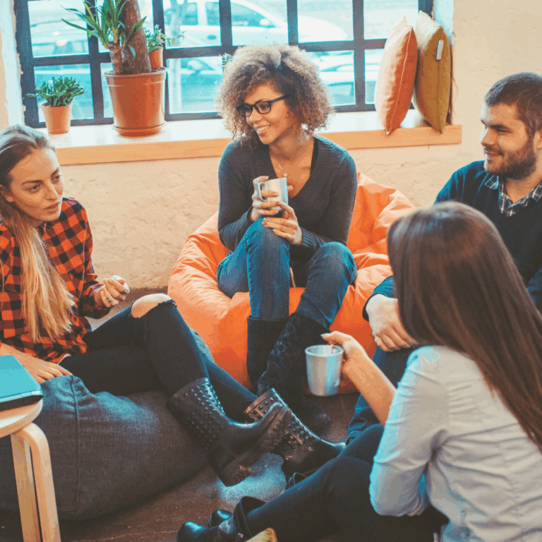 Staff members chatting over coffee in a staff room