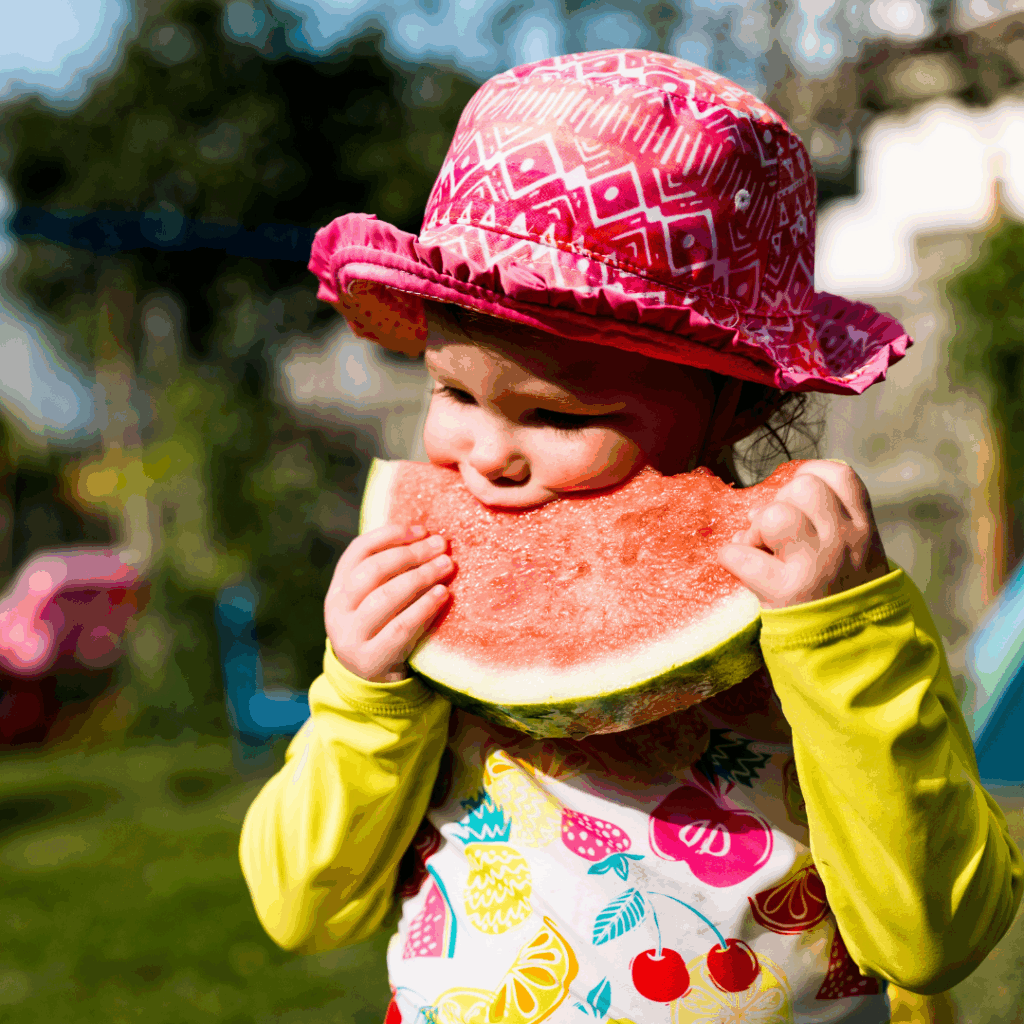 An image of a child eating watermelon