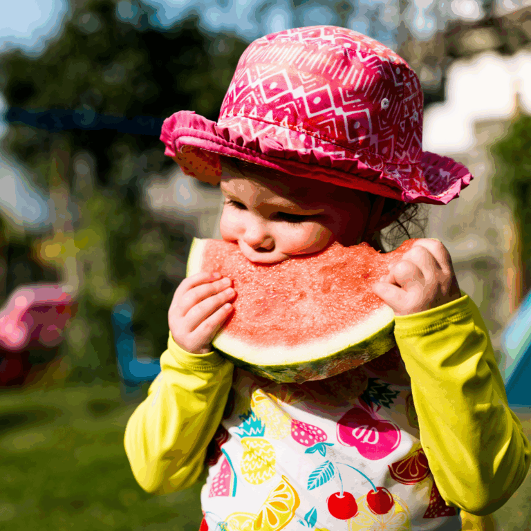 An image of a child eating watermelon