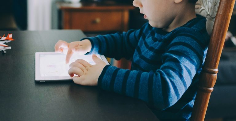 An image of a child at a table reading