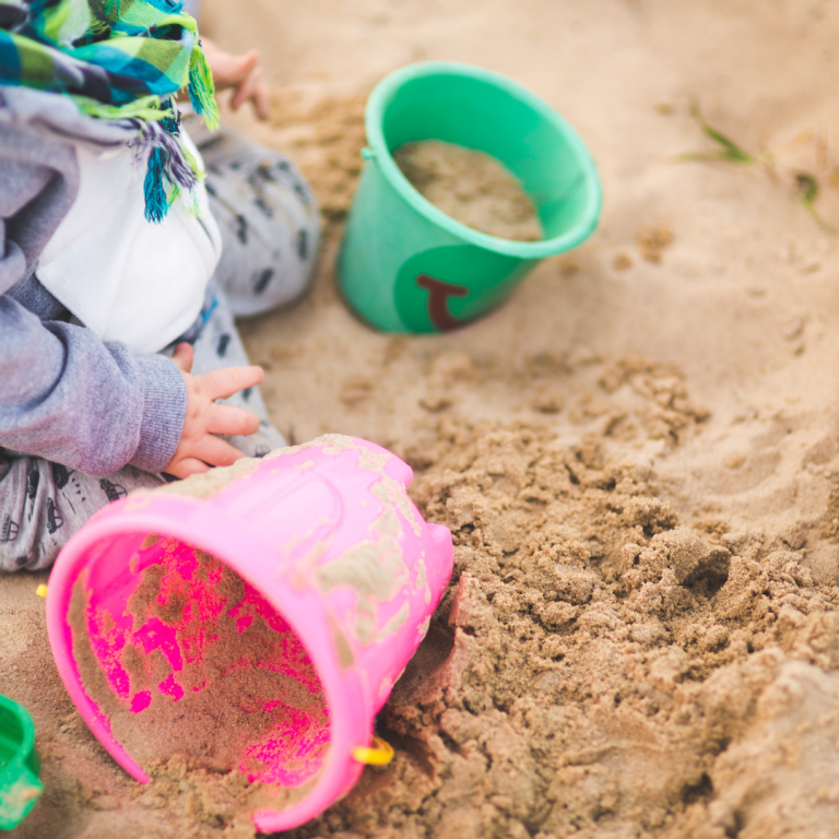 Plastic buckets in a sand pit