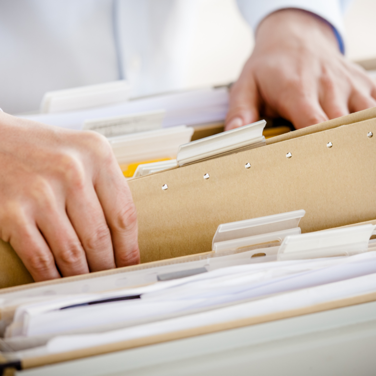 hands searching through files and selecting one