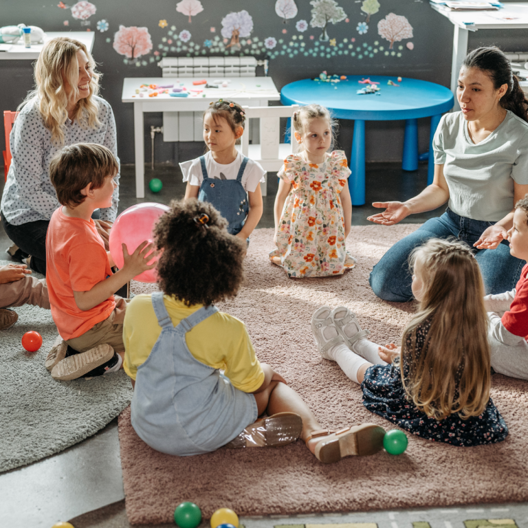 A manager and practitioner with nursery children in the setting