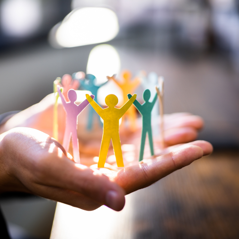 An image of paper people in someone's hand