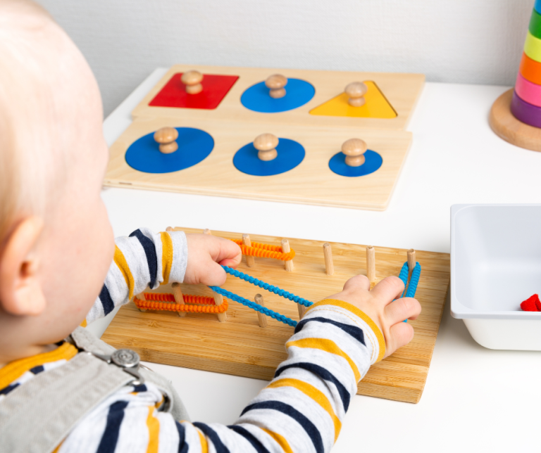 A child learning to stretch bands over pegs