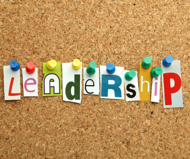 The word Leadership in colourful printed letters pinned to a board